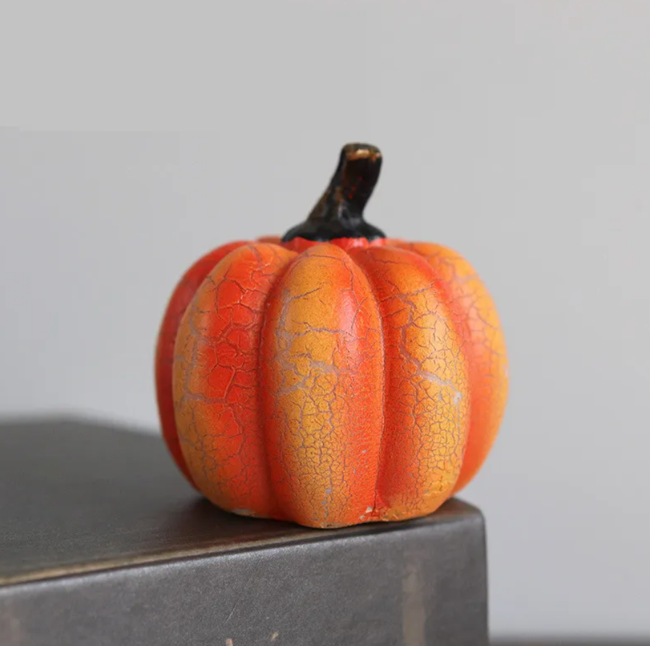 Short crackle-glazed orange resin pumpkin with a dark stem, viewed from the front