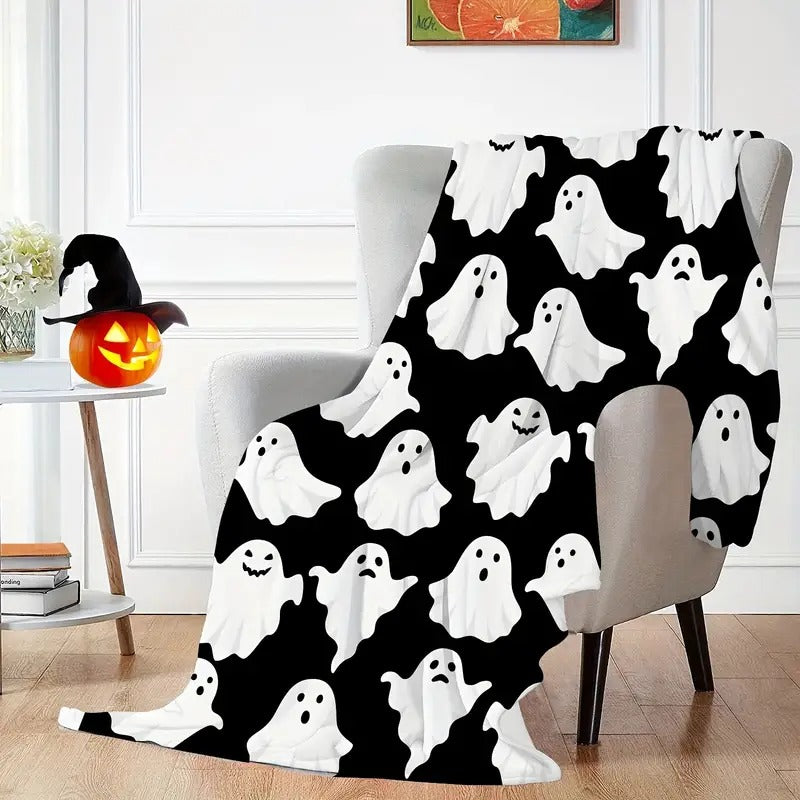 Ghost print flannel throw blanket draped over an armchair in a living room