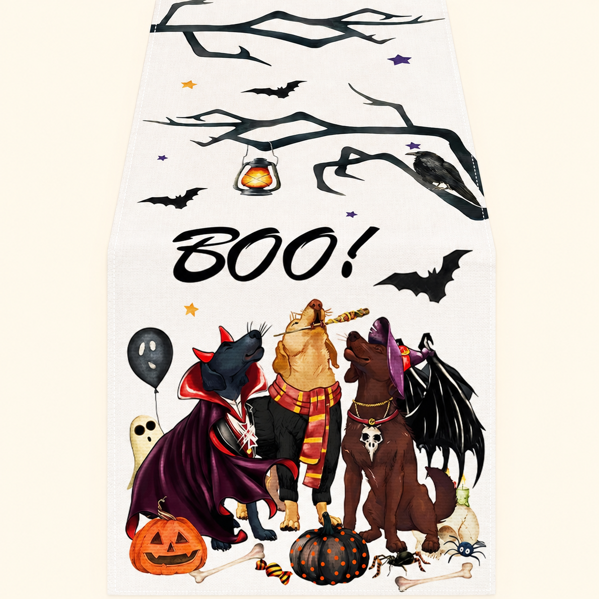 Cream table runner with costumed dogs, bats, branches and BOO lettering on a warm ivory background