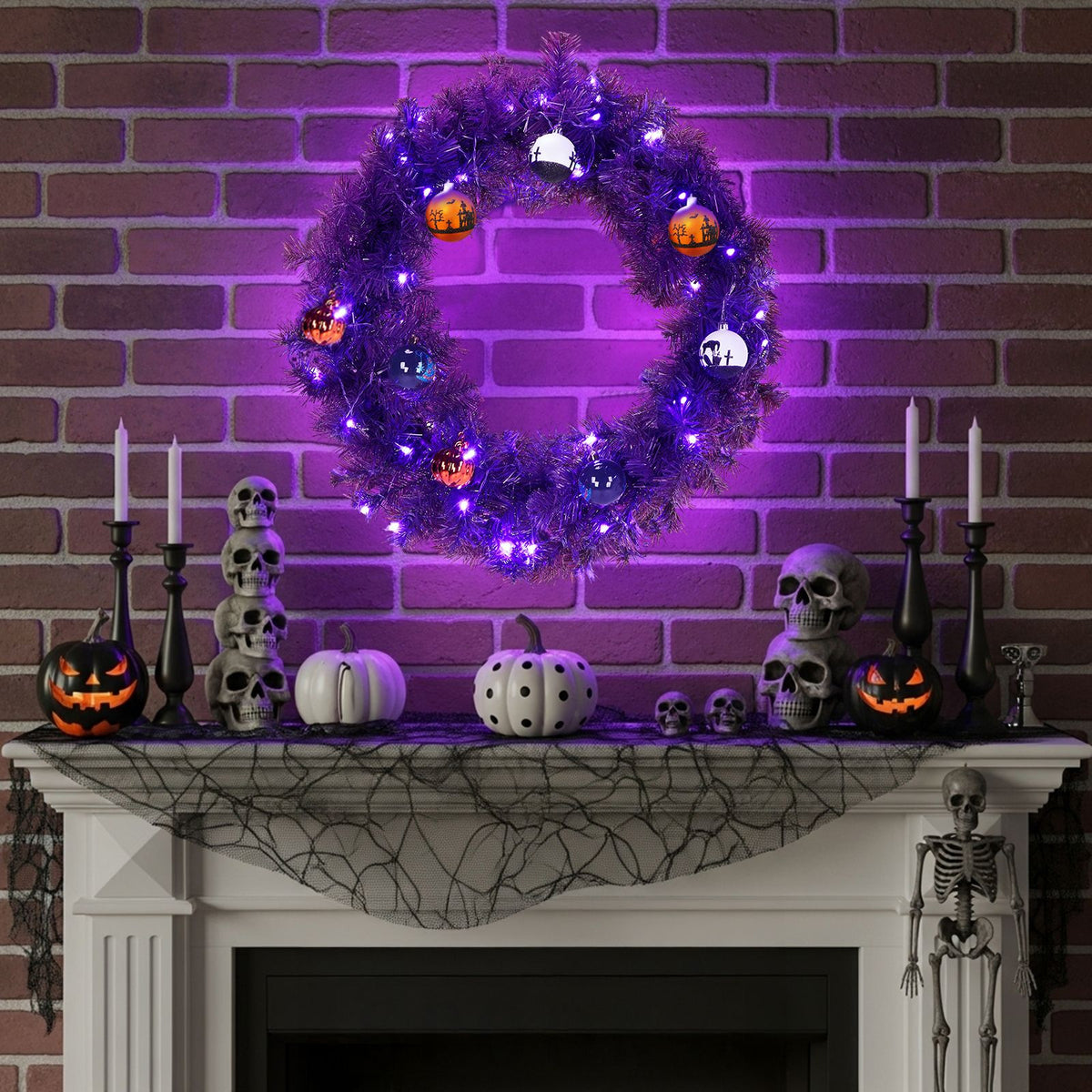 Lit purple Halloween wreath above a mantel styled with skulls and black candlesticks