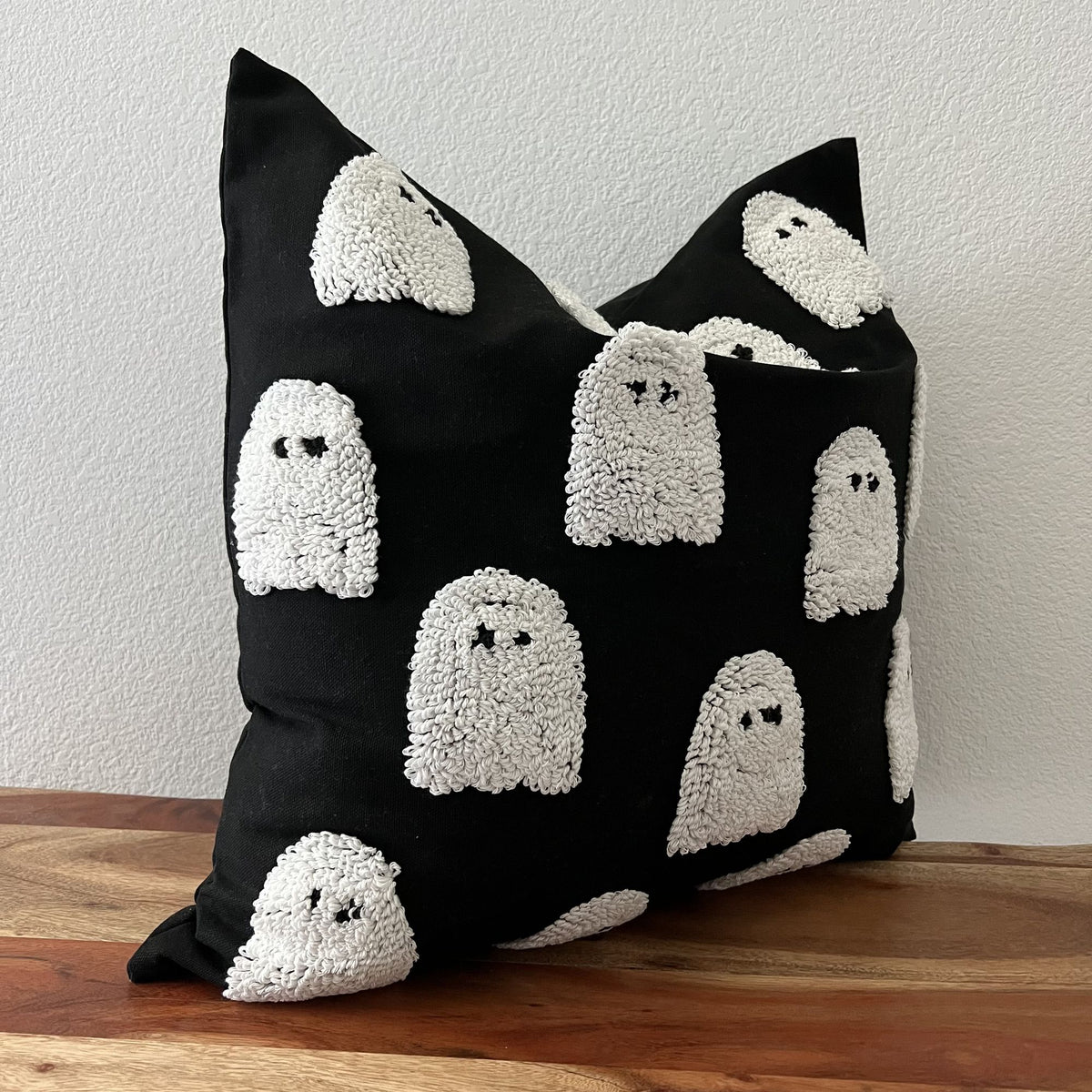 Side view of the black tufted ghost cushion cover showing the raised pile