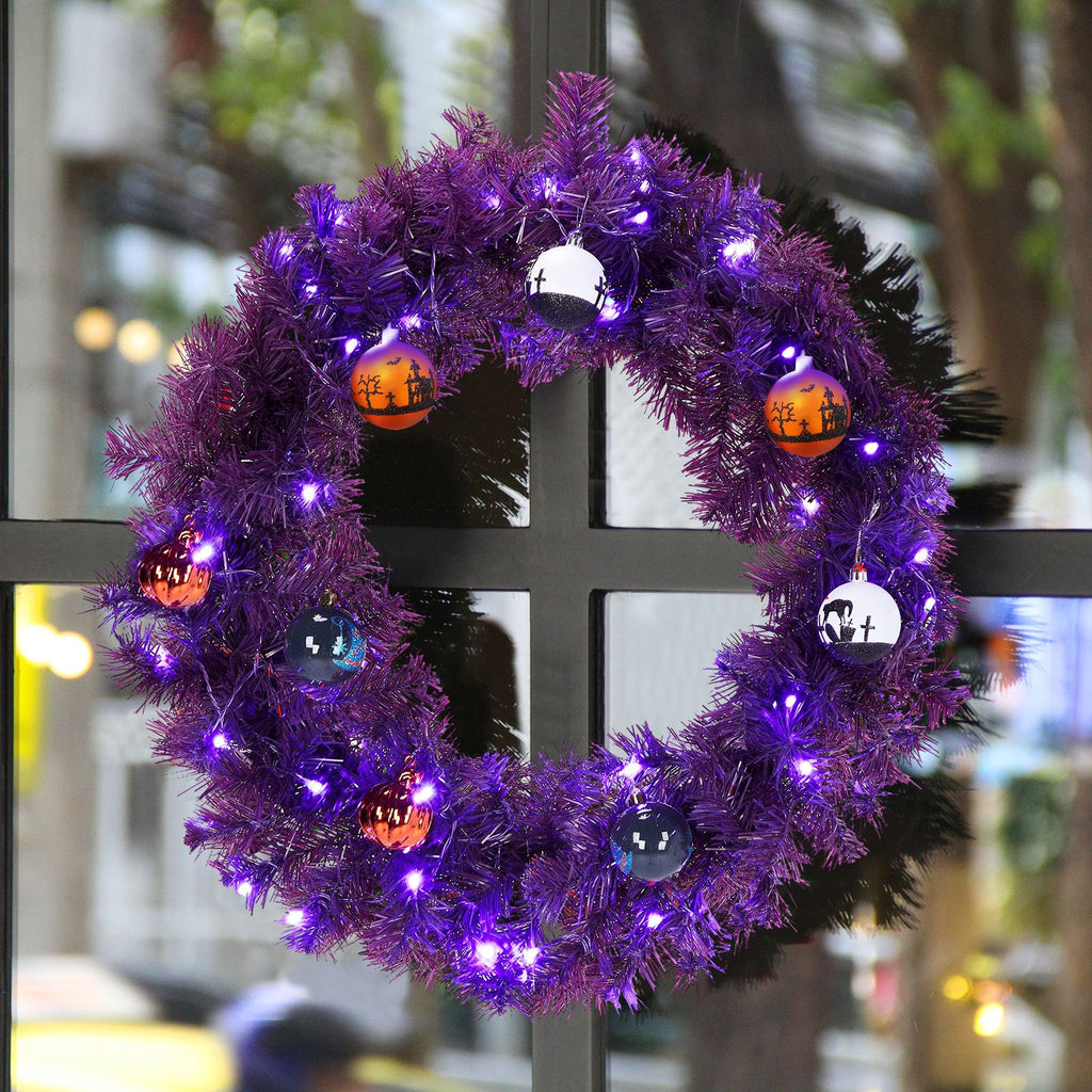 Close-up of the purple wreath lit with purple and orange LEDs on a window frame