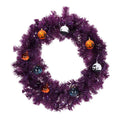 24 inch purple Halloween wreath with clip-on pumpkin, ghost and black cat ornaments, shown unlit on white